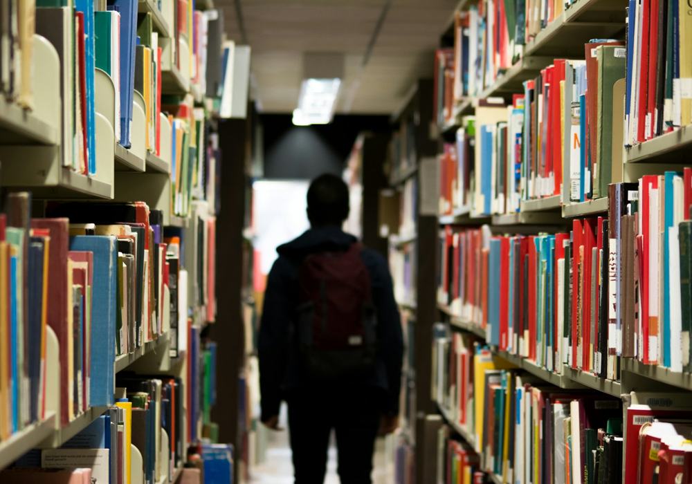 Student browsing library stacks